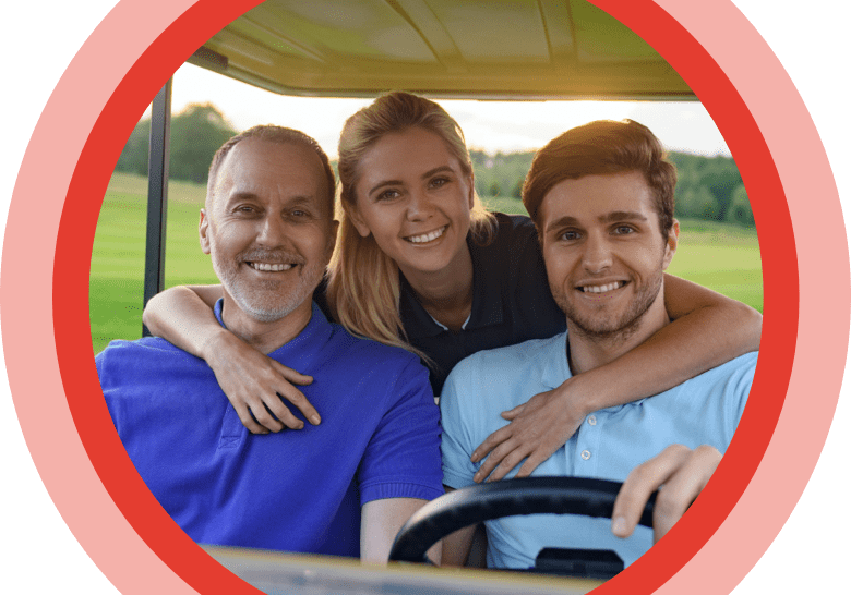 Family smiling on a golf cart.