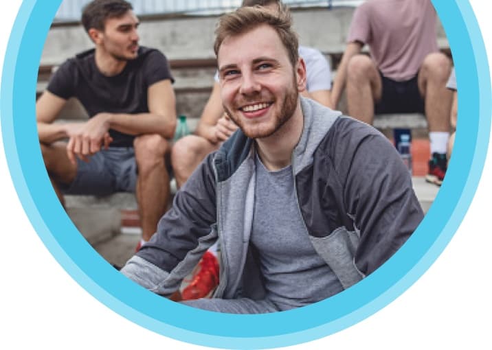 Man smiling with a group of friends.