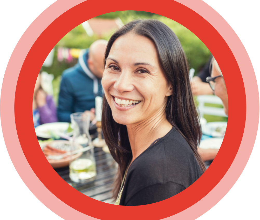 Smiling woman sitting at a table.